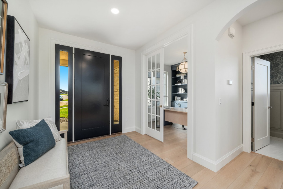Foyer - mid-sized transitional light wood floor and beige floor foyer idea with white walls and a dark wood front door