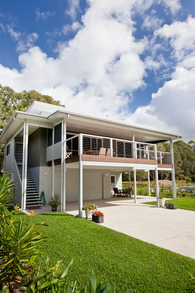 This is an example of a beach style two-storey exterior in Gold Coast - Tweed with concrete fiberboard siding.