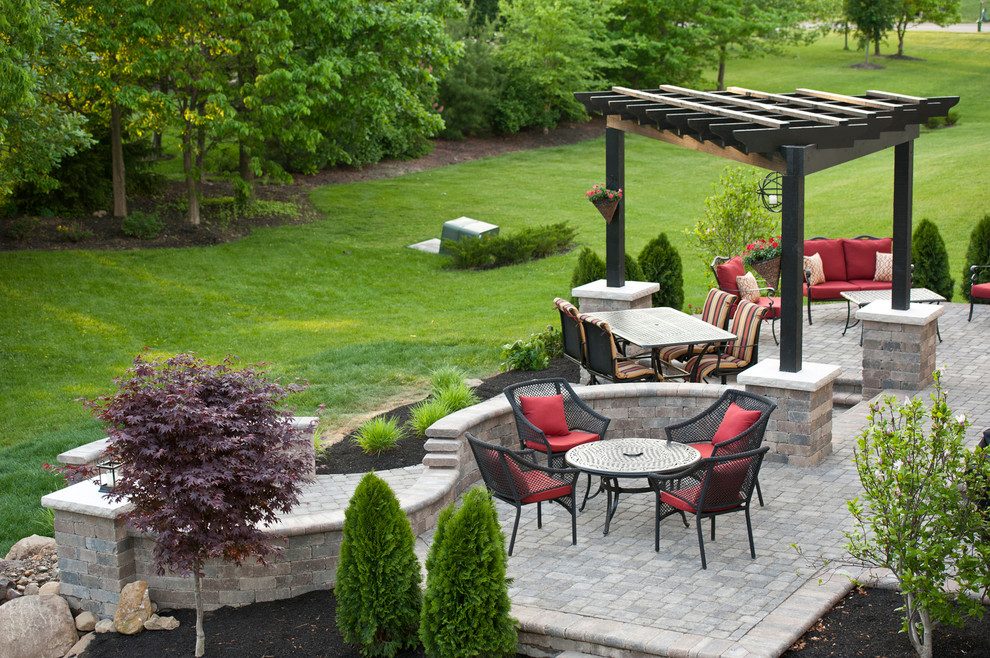 Traditional patio in Columbus with concrete pavers and a pergola.
