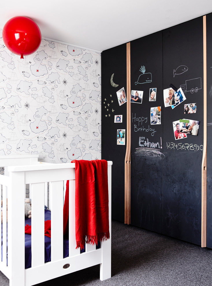 Small contemporary gender-neutral nursery in Melbourne with multi-coloured walls and grey floor.