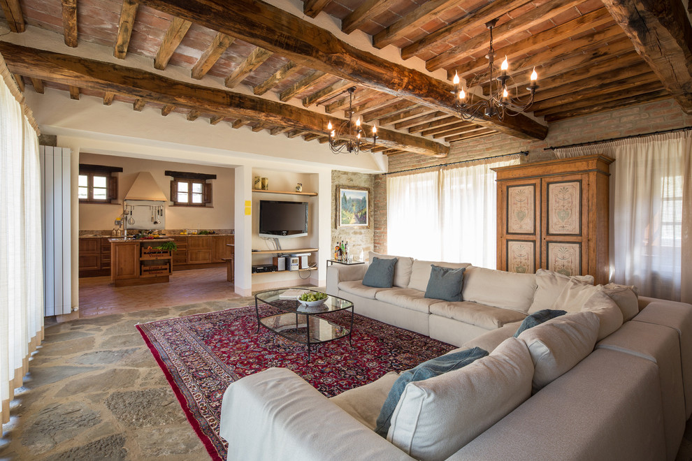 Inspiration for a large mediterranean open concept living room in Florence with white walls and a wall-mounted tv.