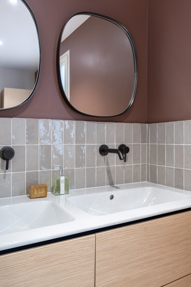 Inspiration for a mid-sized contemporary master bathroom in Paris with beaded inset cabinets, light wood cabinets, a curbless shower, beige tile, ceramic tile, terrazzo floors, a console sink, solid surface benchtops, a hinged shower door, white benchtops, a double vanity and a floating vanity.
