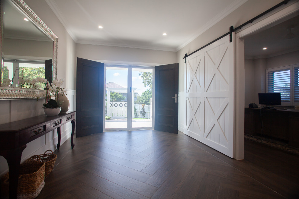 Inspiration for a mid-sized traditional front door in Brisbane with beige walls, dark hardwood floors, a double front door, a dark wood front door and brown floor.