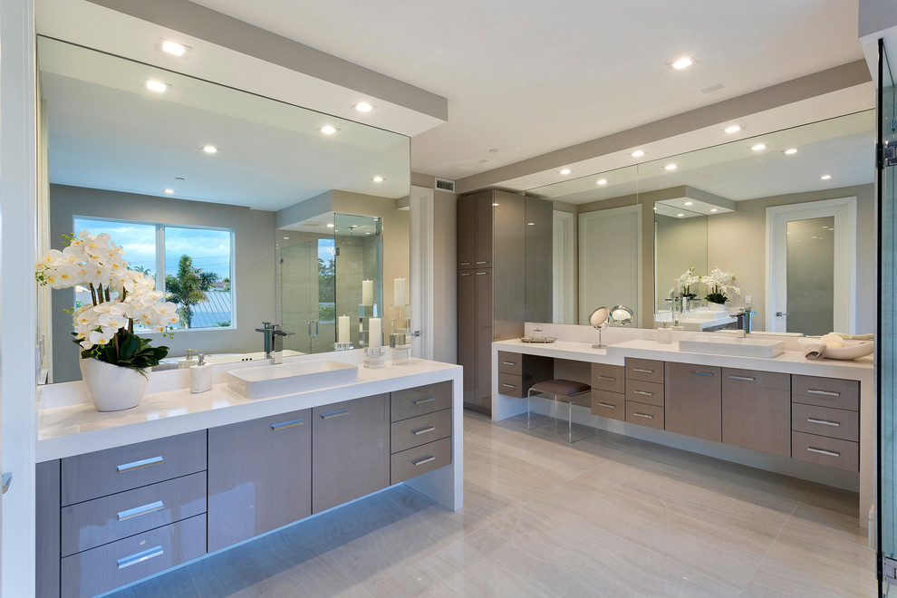 This is an example of a mid-sized contemporary master bathroom in Other with dark wood cabinets, an alcove shower, a one-piece toilet, beige tile, mosaic tile, beige walls, an undermount sink, solid surface benchtops, an open shower, white benchtops, flat-panel cabinets, a freestanding tub, light hardwood floors and beige floor.