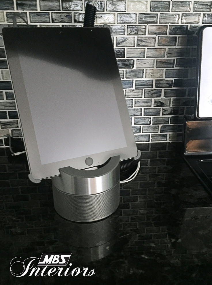 Inspiration for a mid-sized transitional galley ceramic tile and beige floor eat-in kitchen remodel with a farmhouse sink, white cabinets, stainless steel appliances, shaker cabinets, granite countertops, blue backsplash, glass sheet backsplash and an island