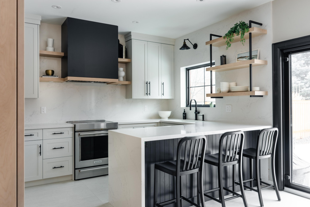This is an example of a mid-sized transitional single-wall separate kitchen in Toronto with an integrated sink, shaker cabinets, white cabinets, quartz benchtops, white splashback, engineered quartz splashback, stainless steel appliances, vinyl floors, with island, white floor and white benchtop.