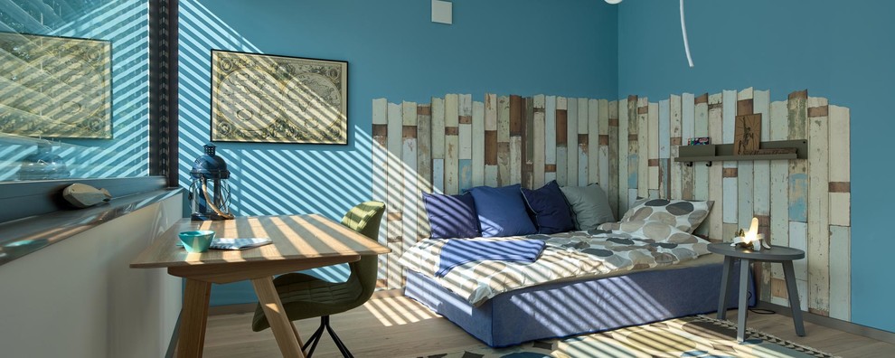 Photo of a contemporary kids' bedroom for boys in Frankfurt with blue walls.