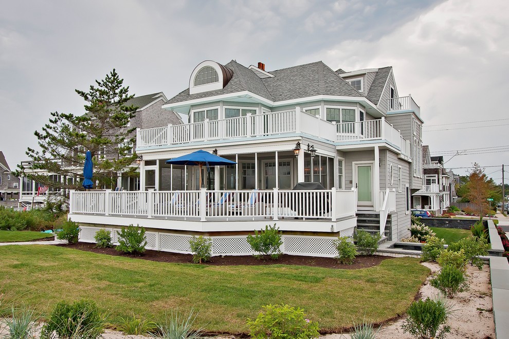 Inspiration for an expansive beach style three-storey grey exterior in New York with vinyl siding.