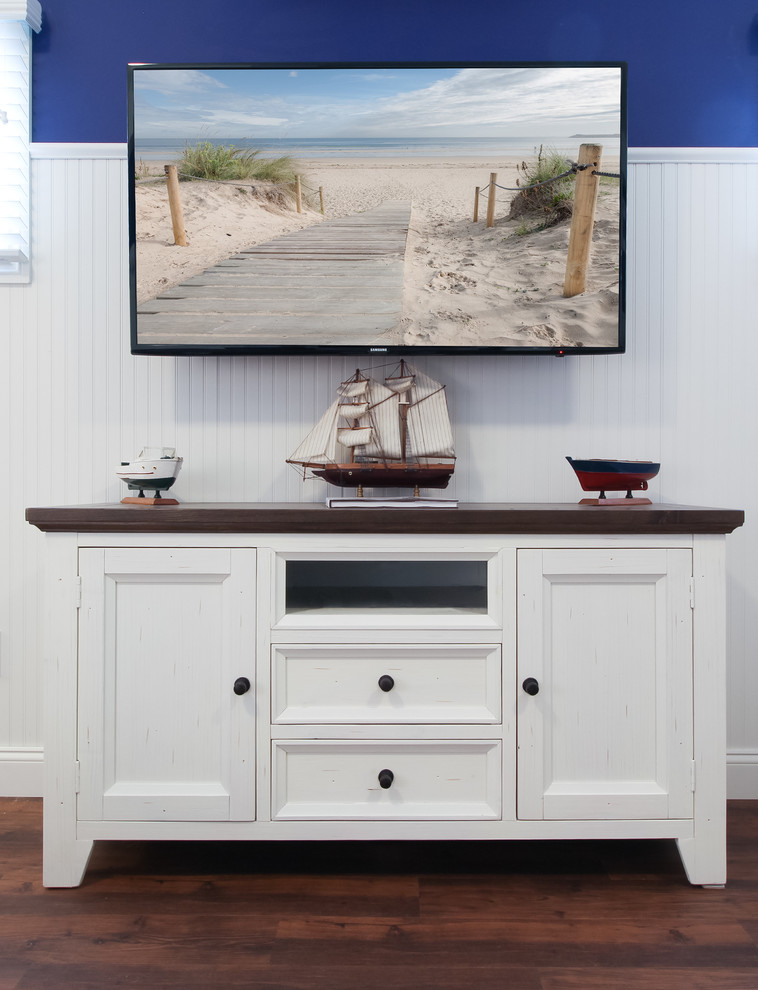 Photo of a mid-sized beach style enclosed family room in New York with blue walls, dark hardwood floors and a wall-mounted tv.