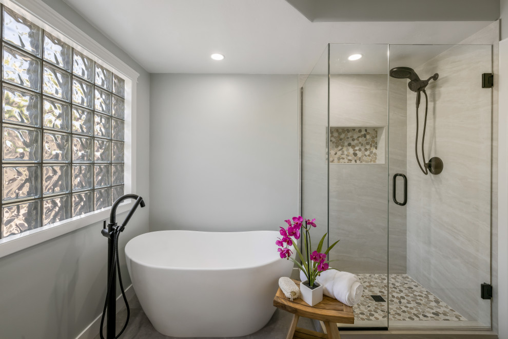 Design ideas for a large traditional ensuite bathroom in Phoenix with a freestanding bath, an alcove shower, white tiles, porcelain tiles, a submerged sink, grey floors, a hinged door, a wall niche, grey walls and porcelain flooring.