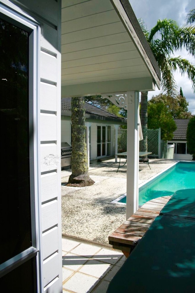 Inspiration for a mid-sized modern backyard rectangular lap pool in Auckland with a hot tub and concrete slab.