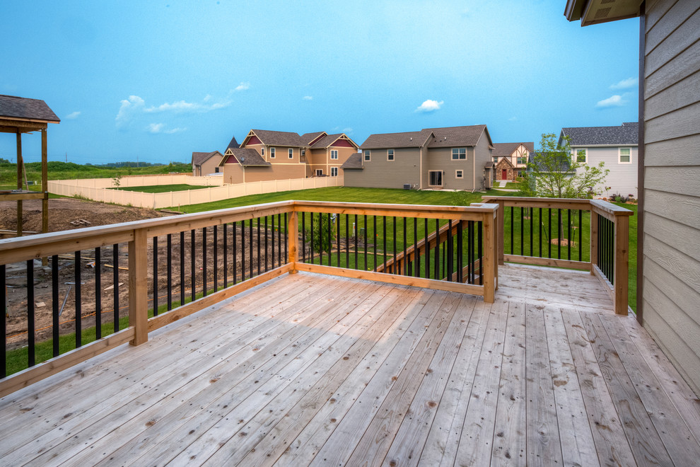 Example of a transitional backyard deck design with no cover