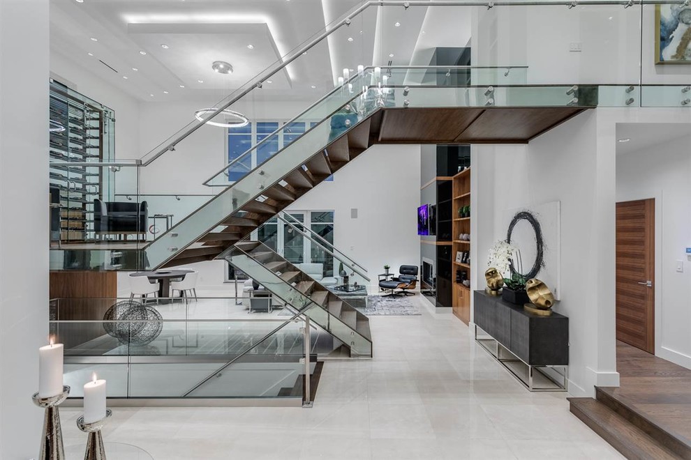 Inspiration for a mid-sized modern wooden u-shaped open and glass railing staircase remodel in Vancouver