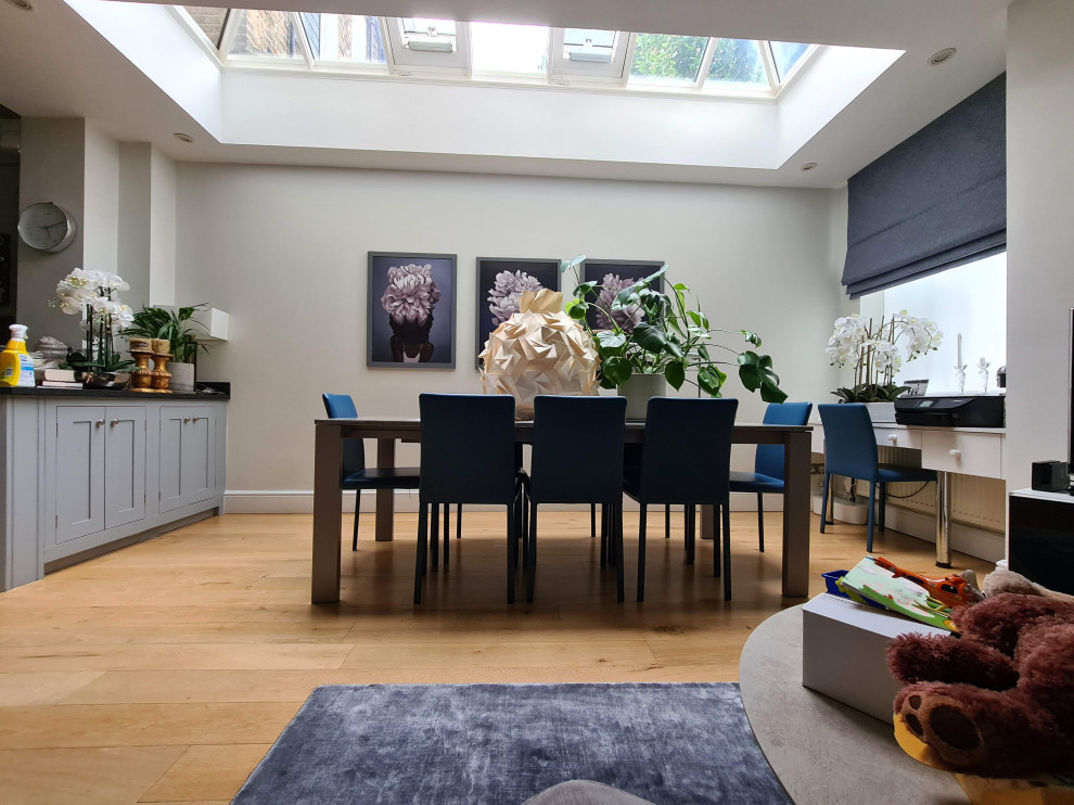 Large classic open plan dining room in London with beige walls, dark hardwood flooring, brown floors and a drop ceiling.