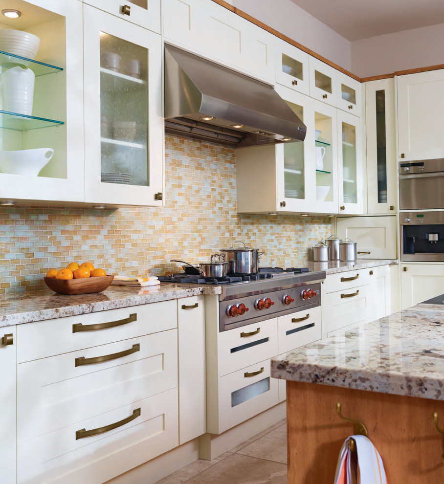 Inspiration for a mid-sized eclectic l-shaped kitchen in Baltimore with flat-panel cabinets, white cabinets, solid surface benchtops, yellow splashback, mosaic tile splashback, stainless steel appliances, ceramic floors and with island.