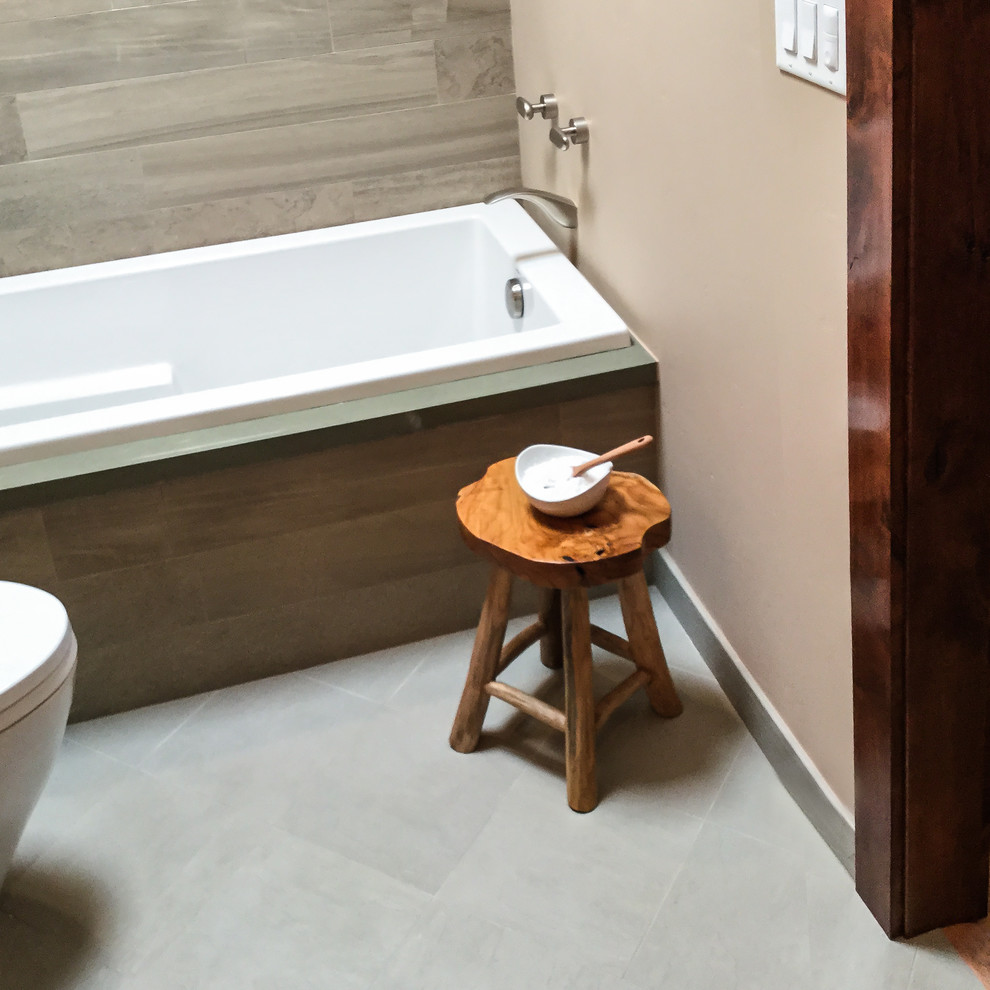Drop-in bathtub - mid-sized transitional master gray tile and porcelain tile cement tile floor and gray floor drop-in bathtub idea with recessed-panel cabinets, dark wood cabinets, beige walls, an undermount sink, quartz countertops and a hinged shower door