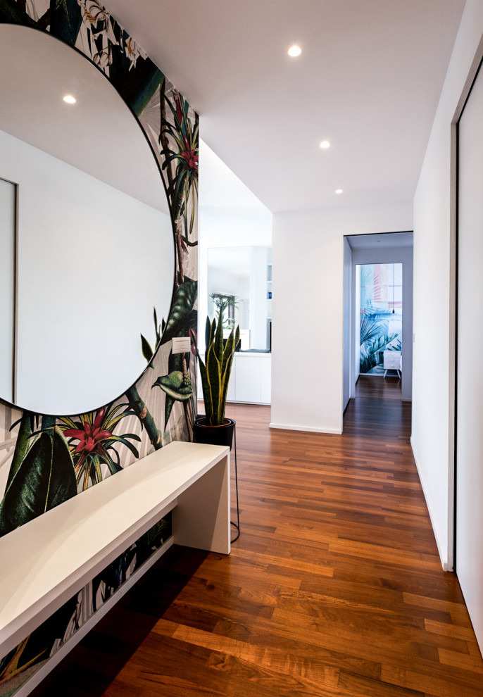 Photo of a small tropical foyer in Milan with white walls, dark hardwood floors, a single front door, a white front door, brown floor and recessed.