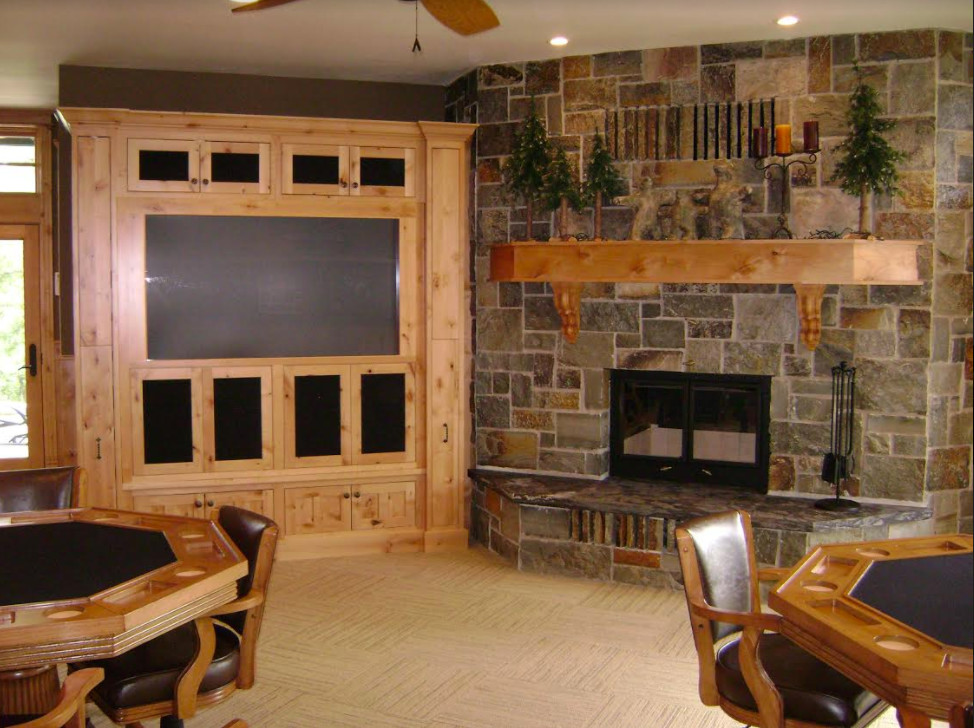 Inspiration for a mid-sized country fully buried basement in San Diego with beige walls, carpet and a standard fireplace.
