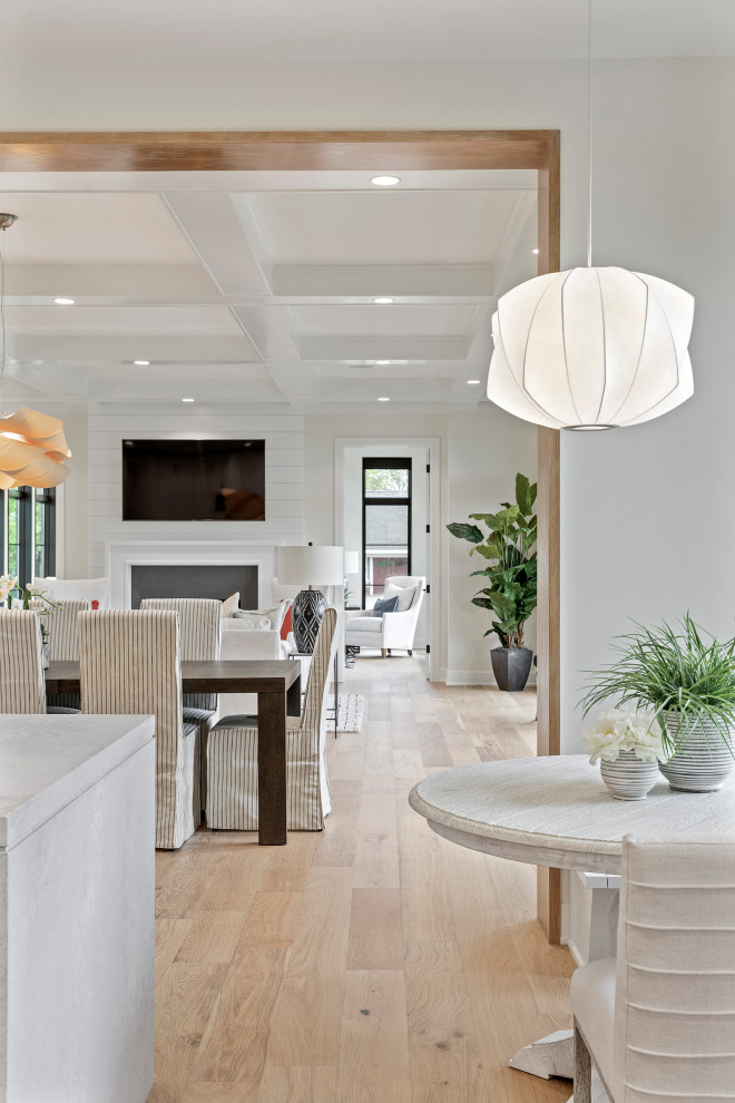 Photo of a large contemporary open plan dining in Minneapolis with white walls, medium hardwood floors and brown floor.
