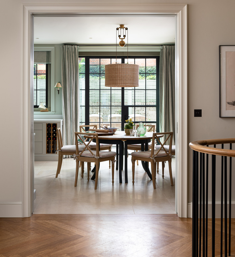 Large traditional kitchen/dining combo in London with limestone floors and beige floor.