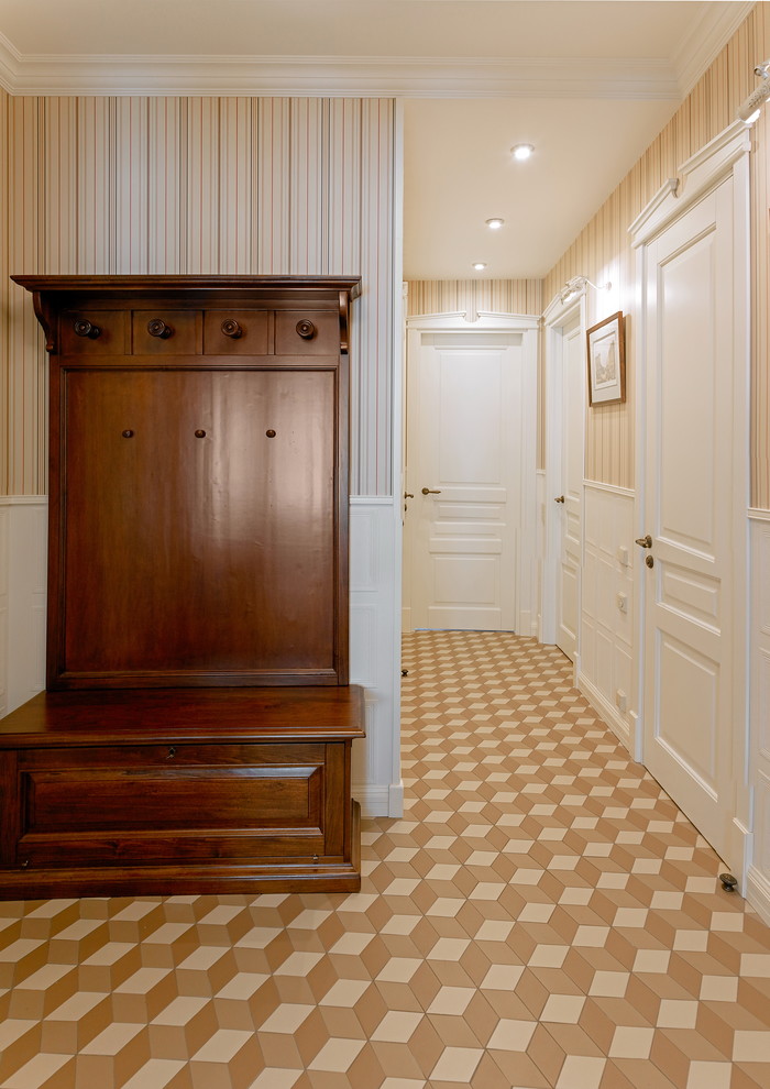 This is an example of a mid-sized traditional entry hall in Moscow with white walls, ceramic floors, a single front door, a white front door, brown floor, recessed and panelled walls.