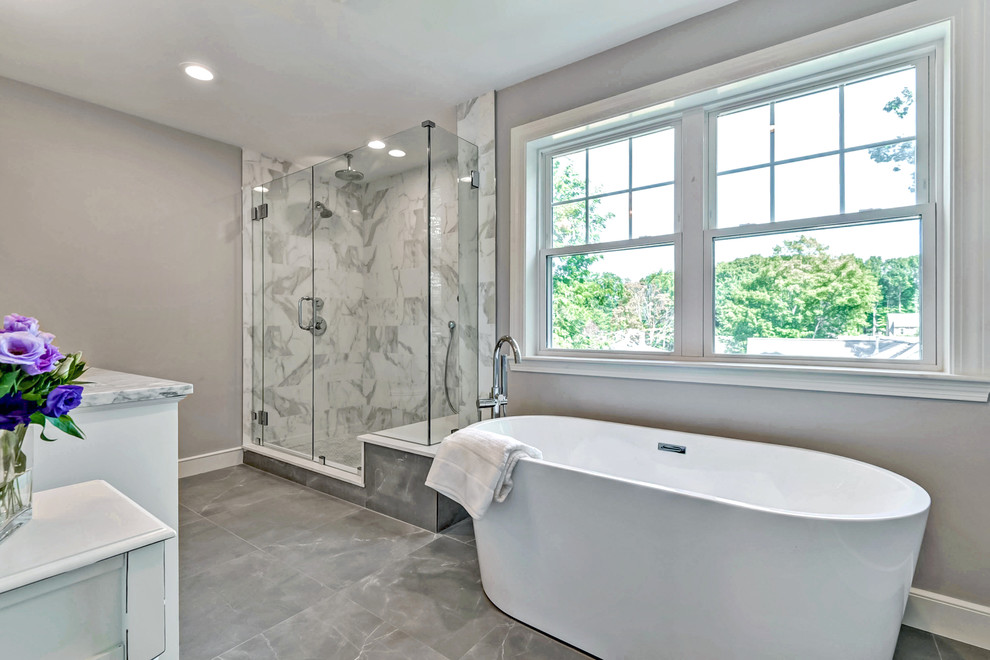 Design ideas for a mid-sized transitional master bathroom in Boston with white cabinets, a freestanding tub, an alcove shower, porcelain tile, grey walls, porcelain floors, marble benchtops, multi-coloured tile and an undermount sink.