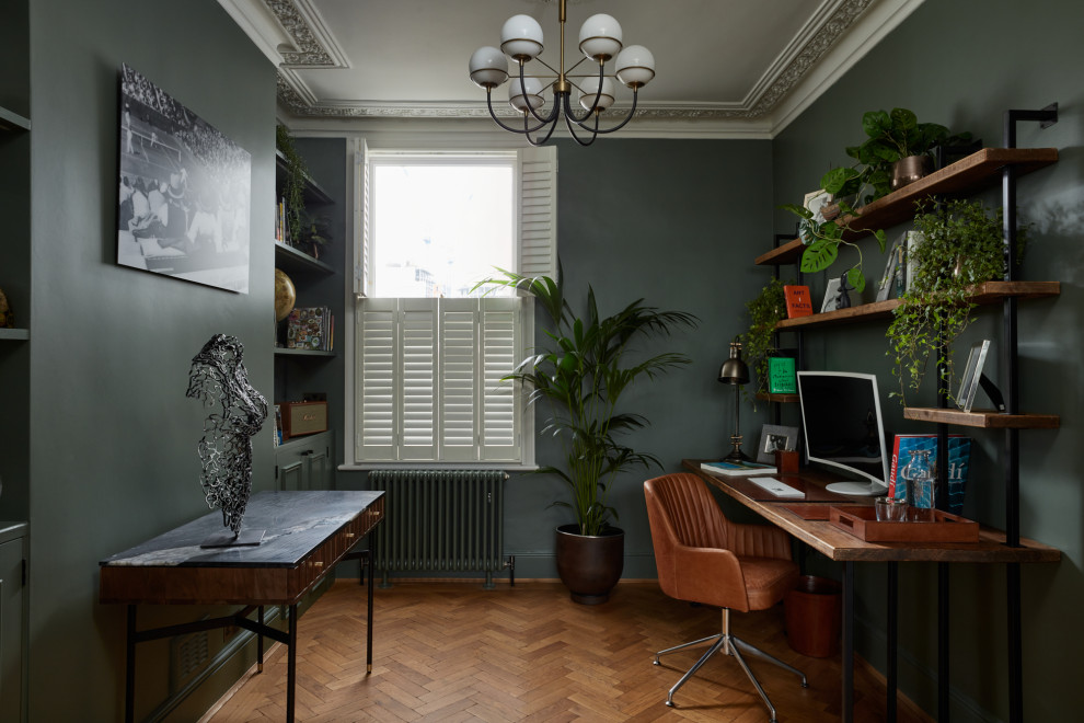This is an example of a mid-sized eclectic home office in London.