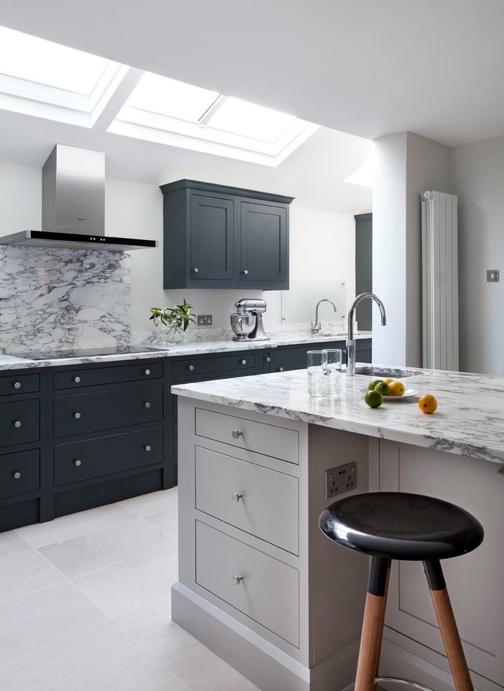 This is an example of a mid-sized contemporary eat-in kitchen in Dublin with an integrated sink, shaker cabinets, grey cabinets, marble benchtops, grey splashback, stone slab splashback, stainless steel appliances, terra-cotta floors and with island.