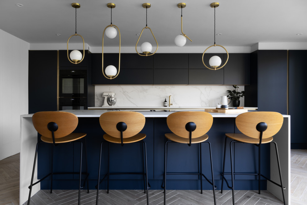 Photo of a large contemporary single-wall open plan kitchen in Other with a built-in sink, flat-panel cabinets, blue cabinets, composite countertops, white splashback, black appliances, porcelain flooring, an island, brown floors, white worktops and feature lighting.