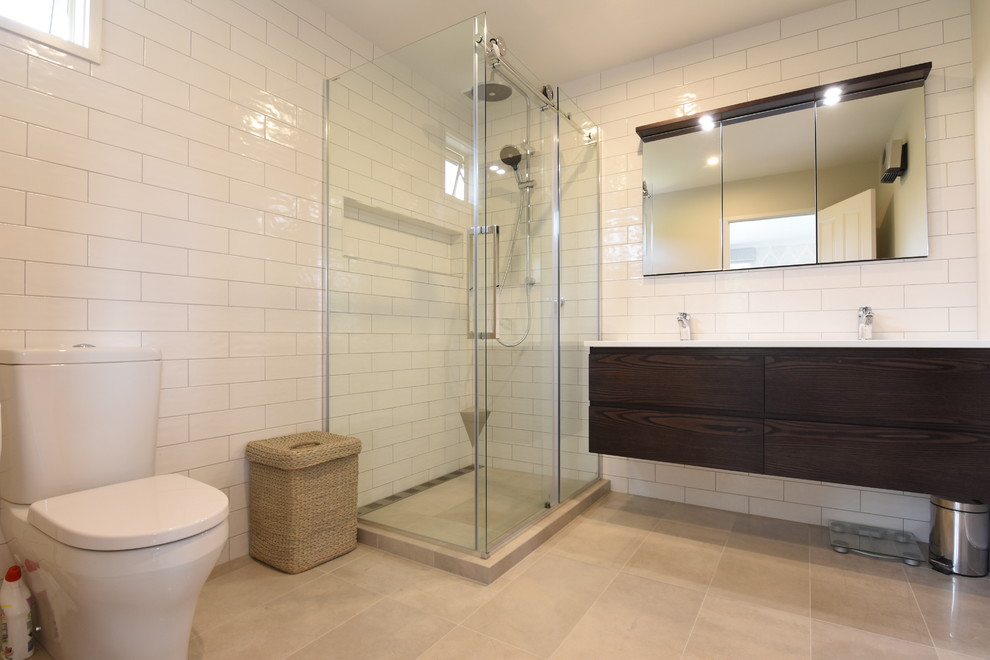 Photo of a transitional master bathroom in Hamilton with a freestanding tub, a corner shower, white tile, ceramic tile, ceramic floors, a trough sink and a sliding shower screen.