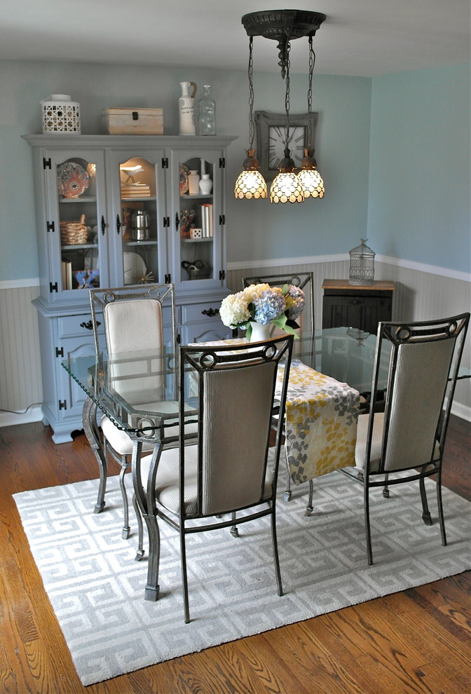 Mid-sized transitional separate dining room in Other with blue walls, medium hardwood floors, no fireplace and brown floor.