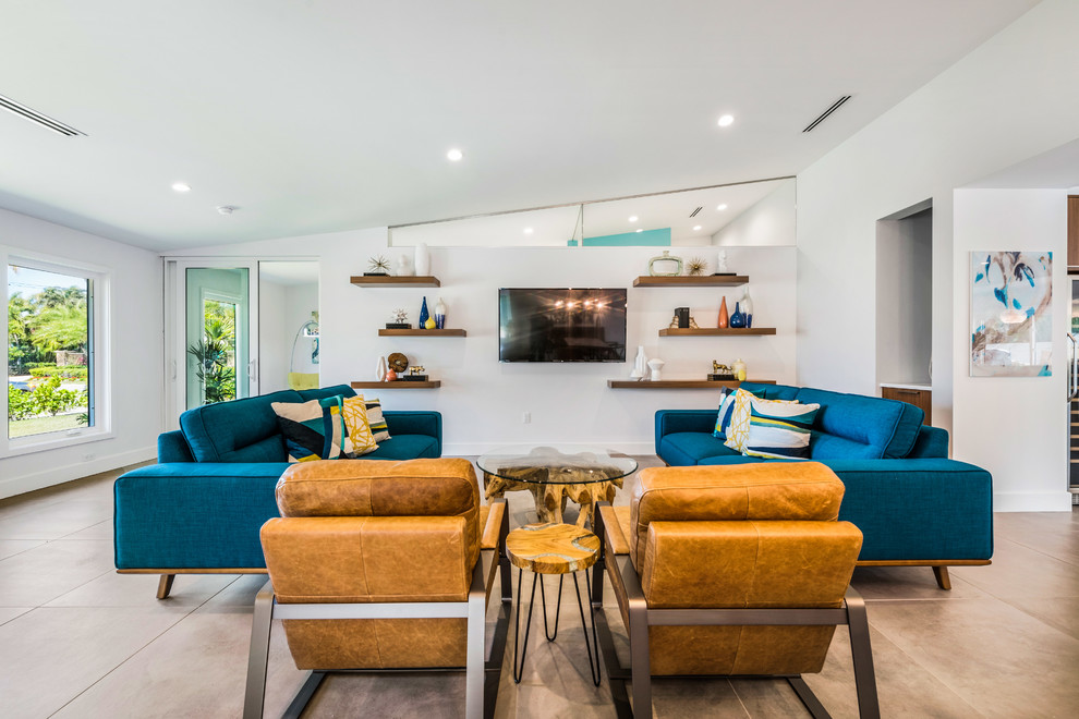 Midcentury open concept family room in Tampa with white walls and a wall-mounted tv.