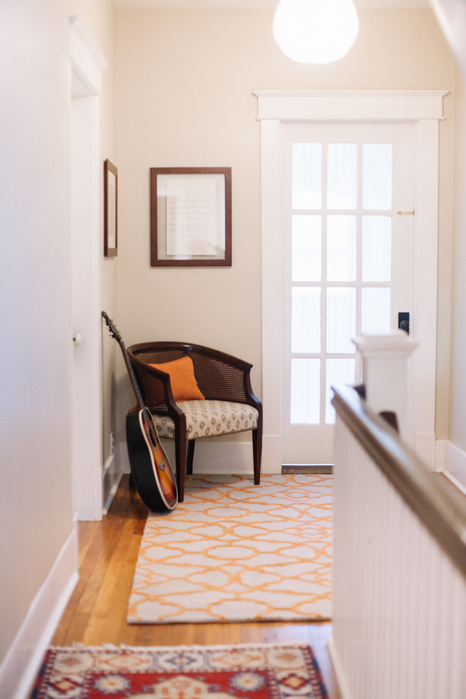 Small transitional light wood floor front door photo in Nashville with white walls and a white front door