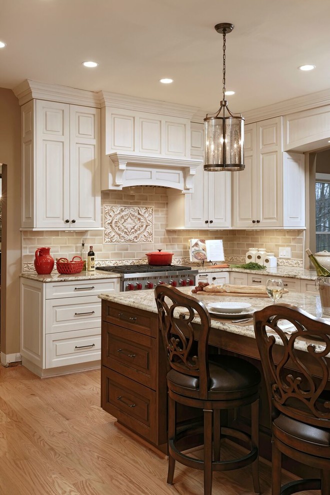 Inspiration for a large traditional u-shaped separate kitchen in DC Metro with an undermount sink, raised-panel cabinets, beige cabinets, granite benchtops, beige splashback, subway tile splashback, stainless steel appliances, medium hardwood floors, with island and brown floor.
