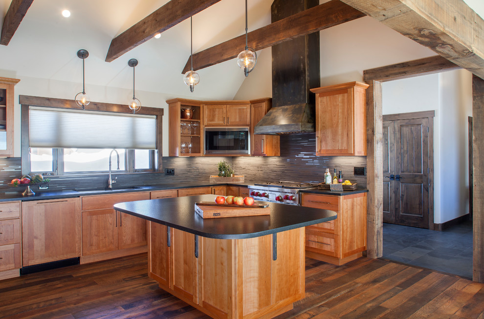 This is an example of a mid-sized country l-shaped eat-in kitchen in Denver with shaker cabinets, granite benchtops, dark hardwood floors, with island, an undermount sink, medium wood cabinets and stainless steel appliances.