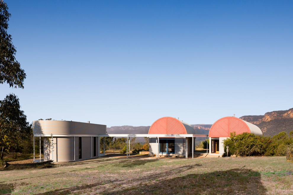 Small contemporary one-storey exterior in Sydney with metal siding.