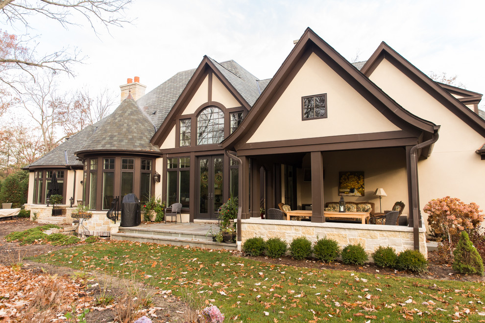 Design ideas for a large traditional two-storey stucco beige exterior in Chicago.