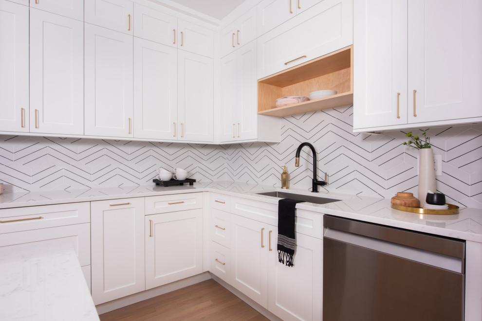 Idéer för ett stort klassiskt vit kök, med en nedsänkt diskho, luckor med infälld panel, vita skåp, bänkskiva i kvarts, vitt stänkskydd, stänkskydd i porslinskakel, rostfria vitvaror, mellanmörkt trägolv, en köksö och brunt golv