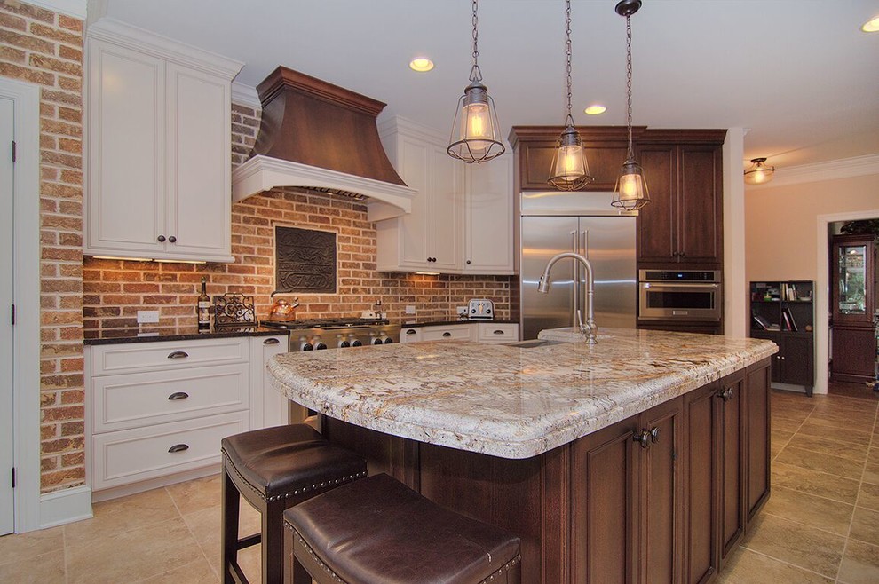 Mid-sized mountain style l-shaped travertine floor and beige floor eat-in kitchen photo in Charlotte with a farmhouse sink, beaded inset cabinets, white cabinets, granite countertops, red backsplash, brick backsplash, stainless steel appliances and an island