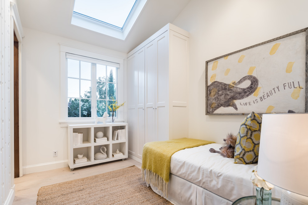This is an example of a mid-sized transitional master bedroom in San Francisco with white walls, light hardwood floors, no fireplace, beige floor and vaulted.