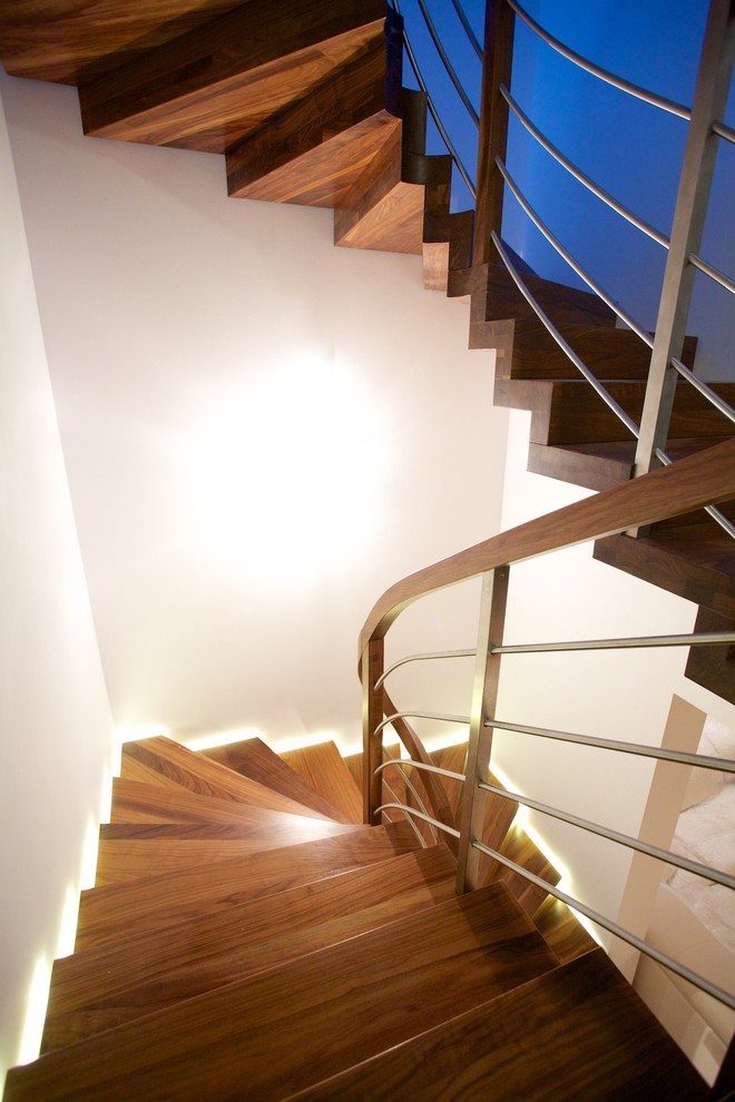 Design ideas for a large contemporary wood curved staircase in Other with wood risers.