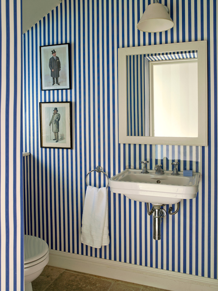 Photo of a traditional powder room in London with a wall-mount sink and blue walls.