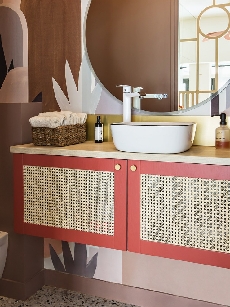 Photo of a small contemporary cloakroom in Other with beaded cabinets, beige cabinets, a wall mounted toilet, multi-coloured walls, terrazzo flooring, a built-in sink, wooden worktops, beige worktops, a floating vanity unit and wallpapered walls.