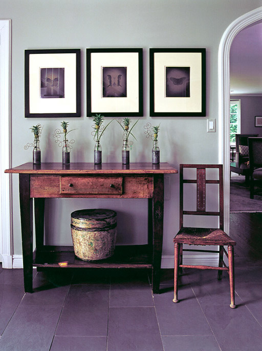 Photo of a mid-sized country foyer in Chicago with grey walls and slate floors.