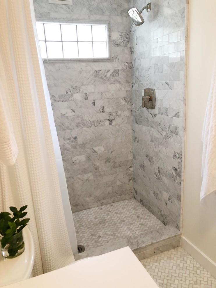 This is an example of a small transitional master bathroom in Providence with furniture-like cabinets, white cabinets, an alcove shower, gray tile, marble, white walls, marble floors, an undermount sink, marble benchtops, grey floor, a shower curtain and white benchtops.