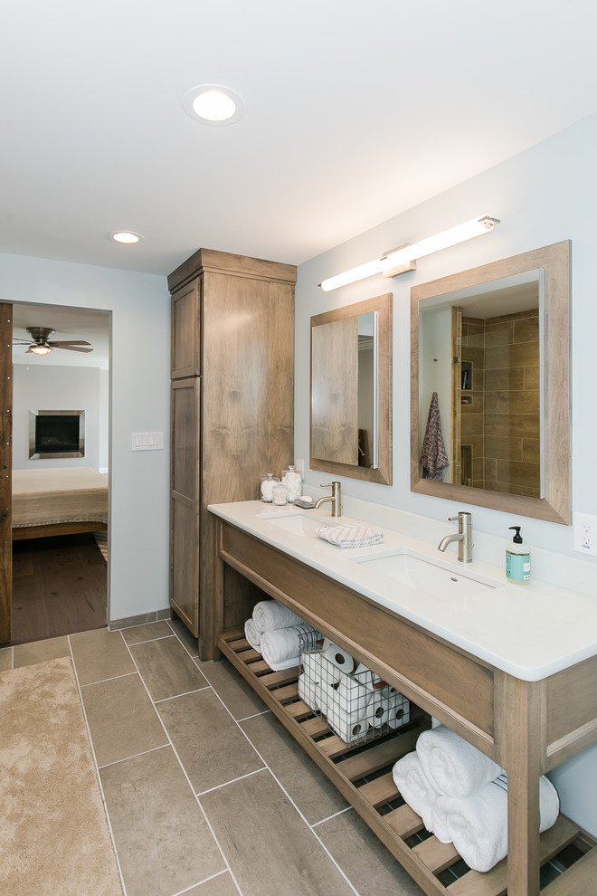 Small arts and crafts master bathroom in St Louis with shaker cabinets, medium wood cabinets, a freestanding tub, an open shower, a one-piece toilet, brown tile, ceramic tile, grey walls, ceramic floors, an undermount sink, engineered quartz benchtops and beige floor.