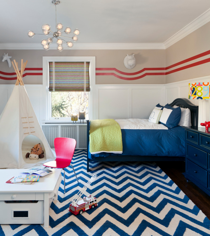 Vine - Transitional medium tone wood floor and wainscoting childrens' room photo in Denver with beige walls