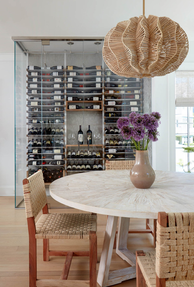 Photo of a beach style dining room in New York with light hardwood floors and brown floor.