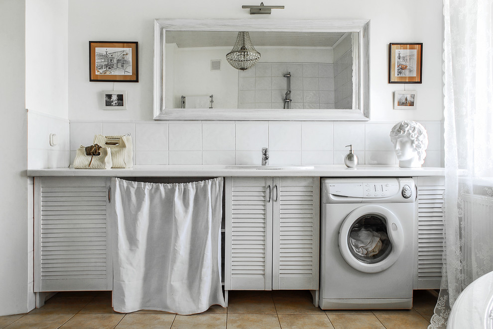 Photo of a country bathroom in Moscow with louvered cabinets, white cabinets, an open shower, white walls, a drop-in sink, white tile, porcelain floors, solid surface benchtops and a laundry.