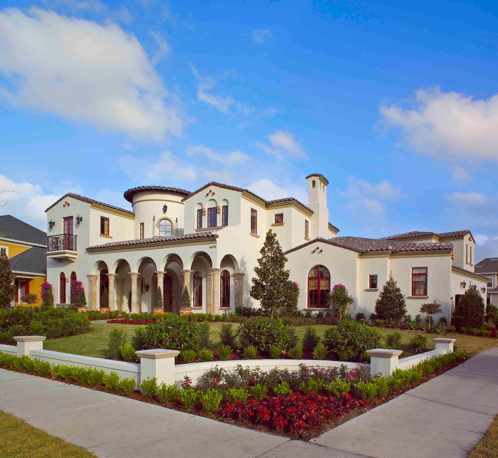 Photo of an expansive mediterranean two-storey stucco beige exterior in Orlando.